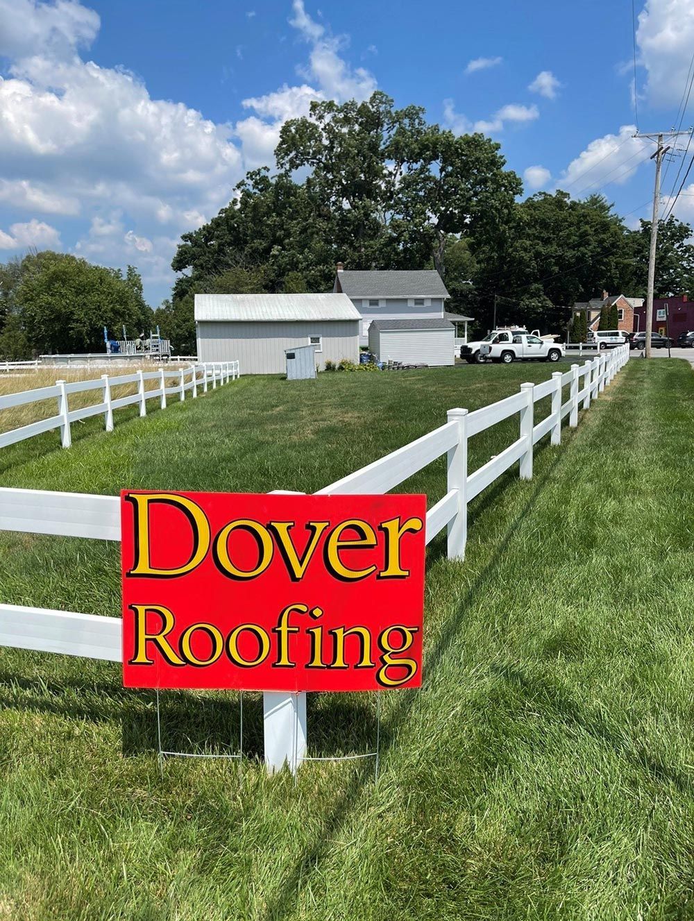 Dover Roofing Sign Next to a White Fence — Mount Wolf, PA — Dover Roofing Services