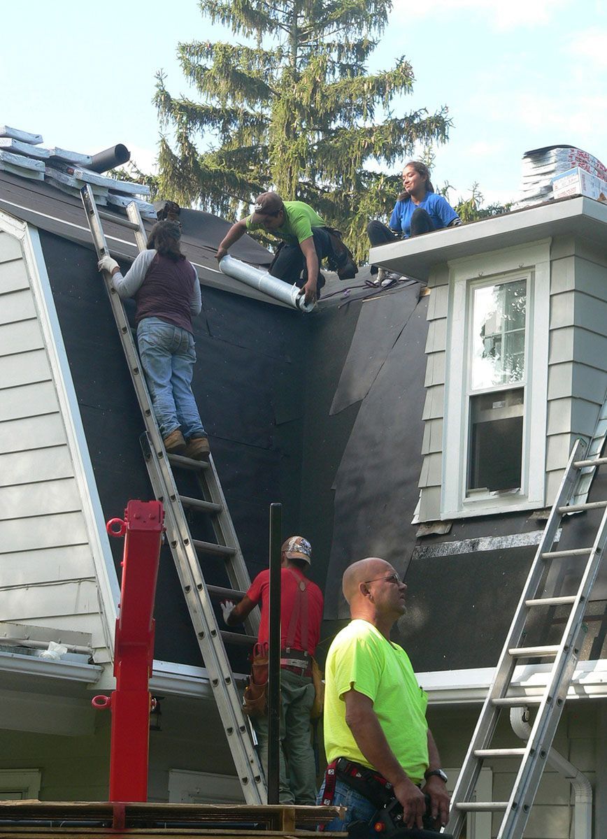 Red metal tile rooftop with wood soffit and fascia — Mount Wolf, PA — Dover Roofing Services