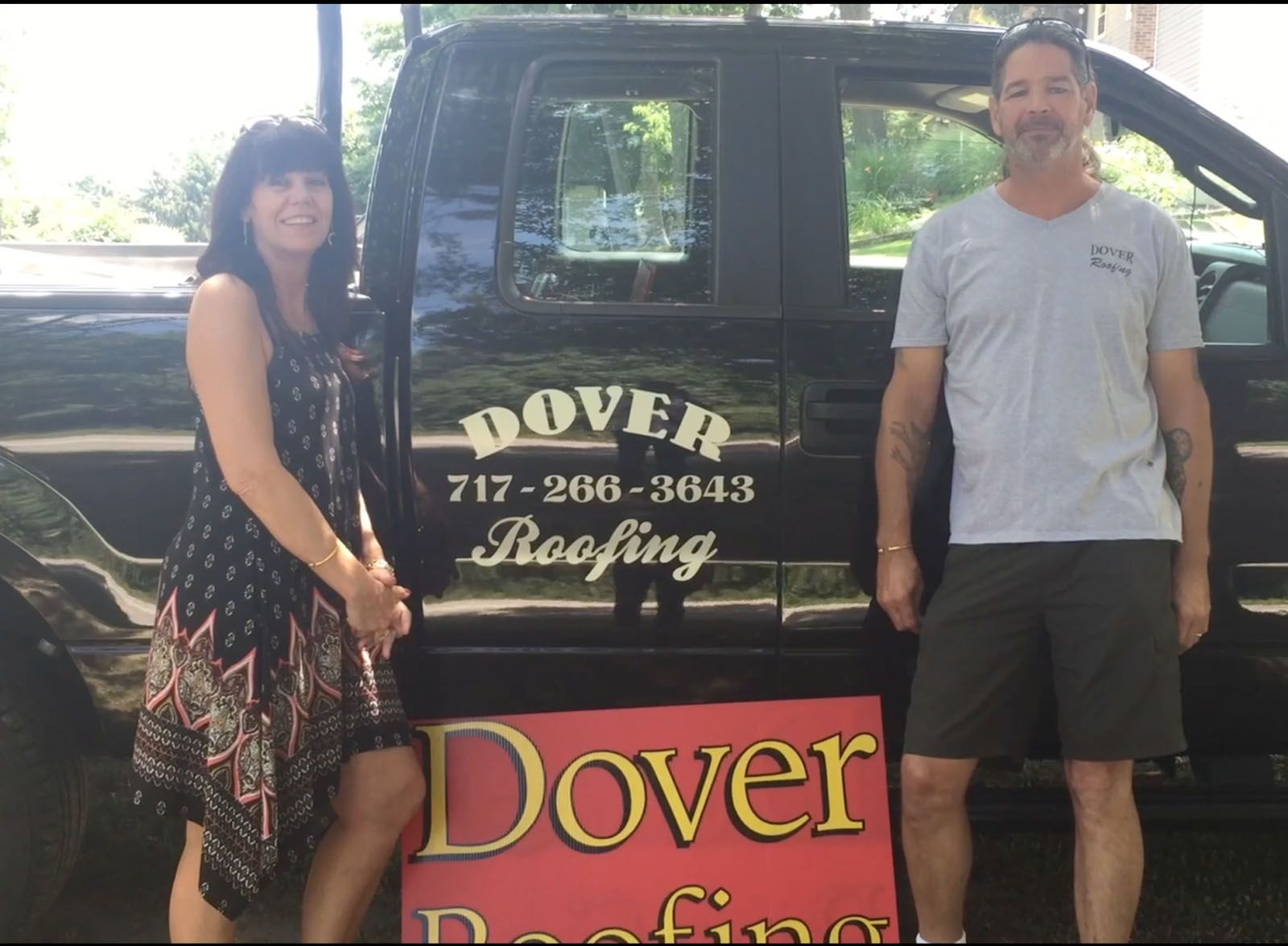 Man and woman in front of the black pickup truck — Mount Wolf, PA — Dover Roofing Services