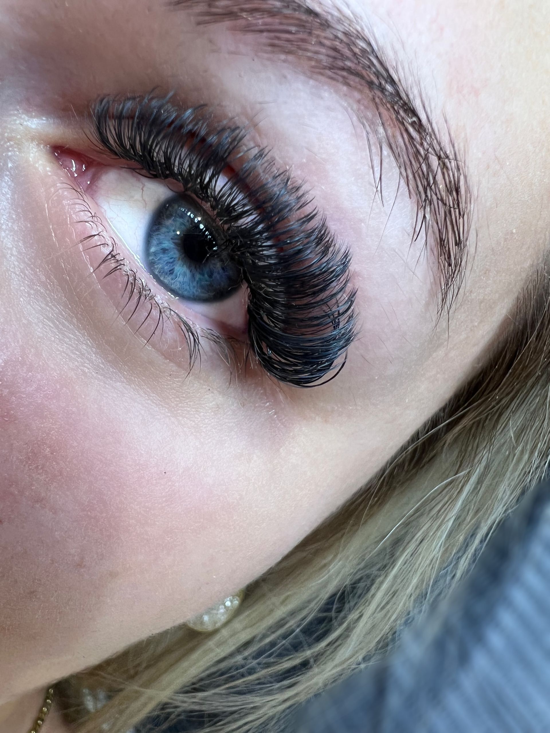 Eine Nahaufnahme des Auges einer Frau mit langen Wimpern.