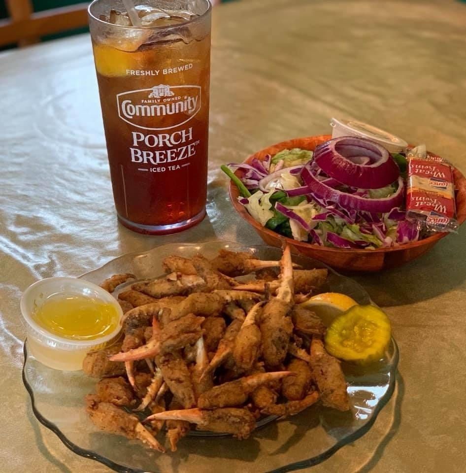 A glass of community porch breeze next to a plate of food