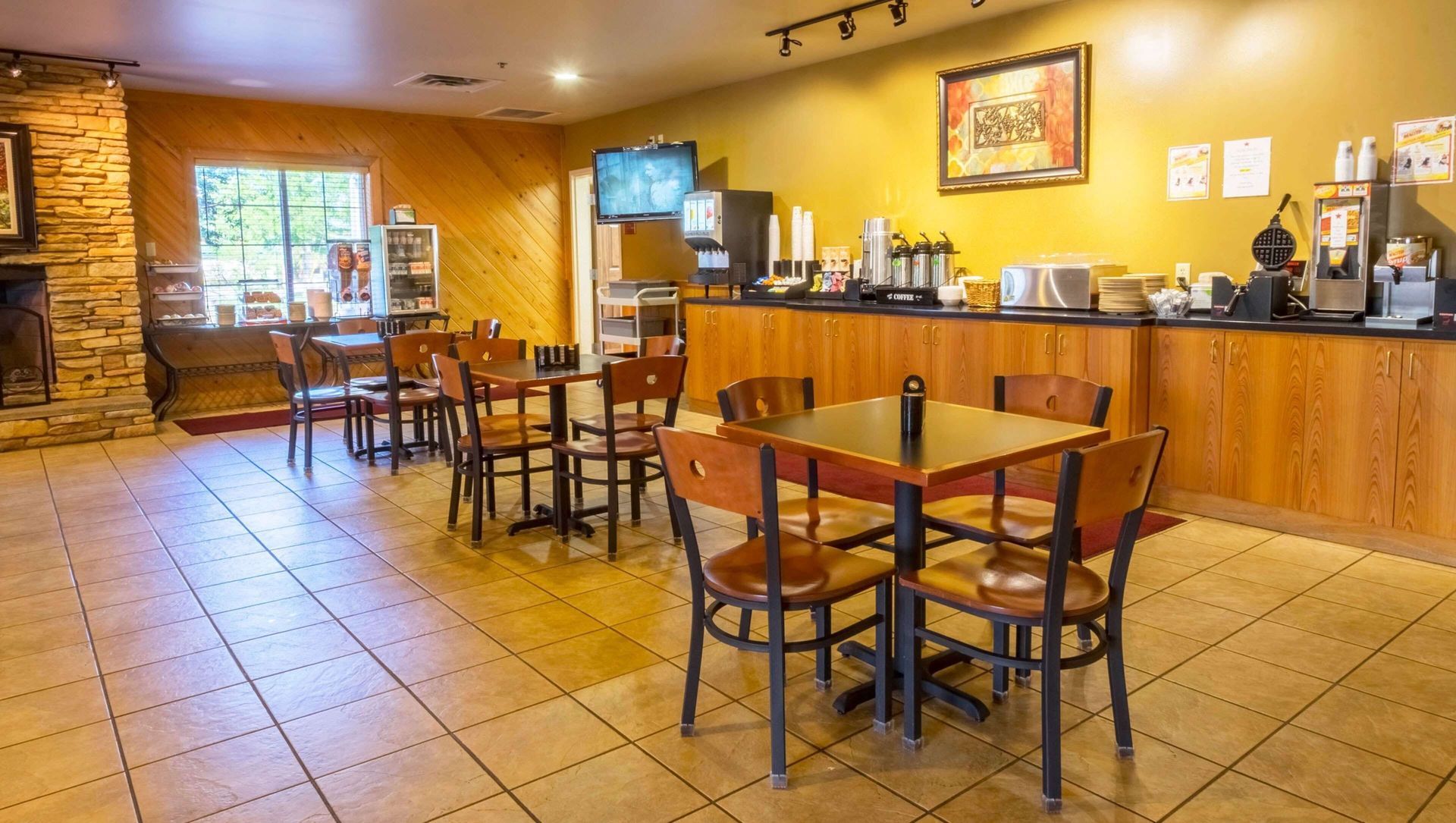 A restaurant with tables and chairs and a counter.