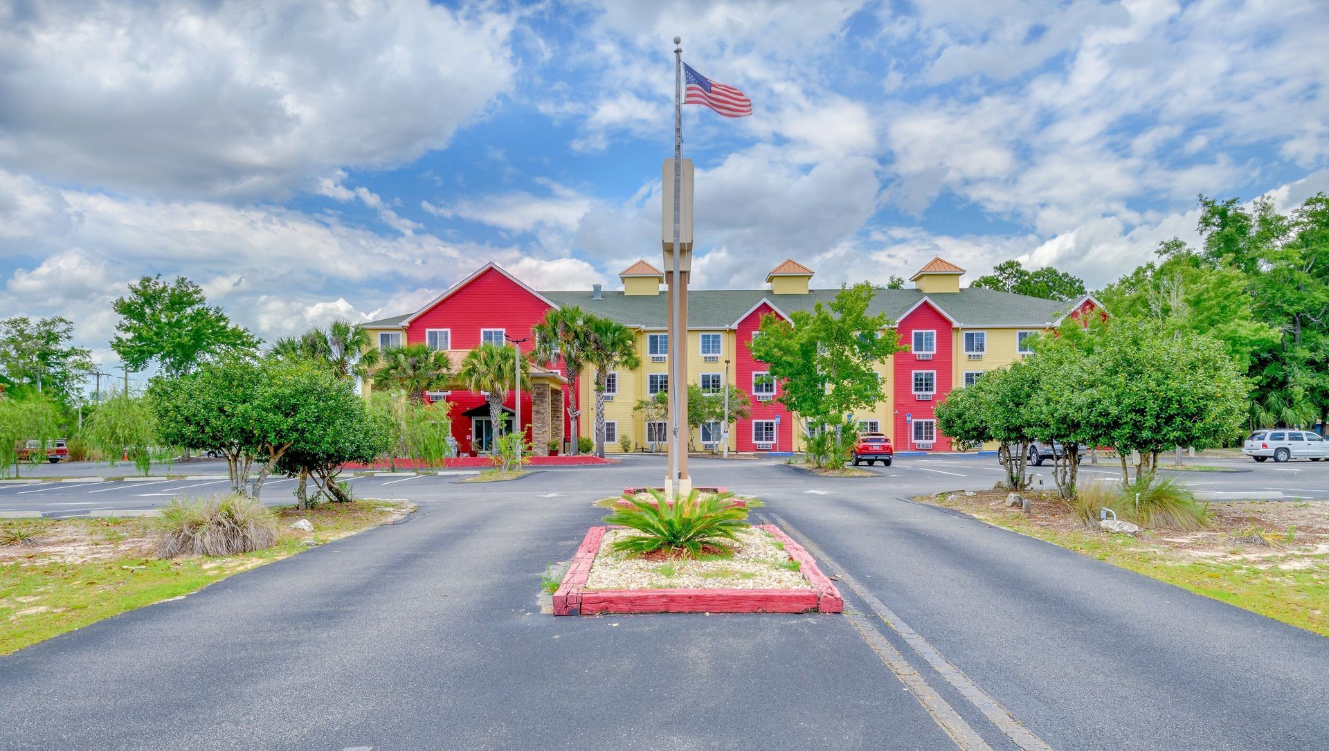 A large red building with a flag pole in front of it
