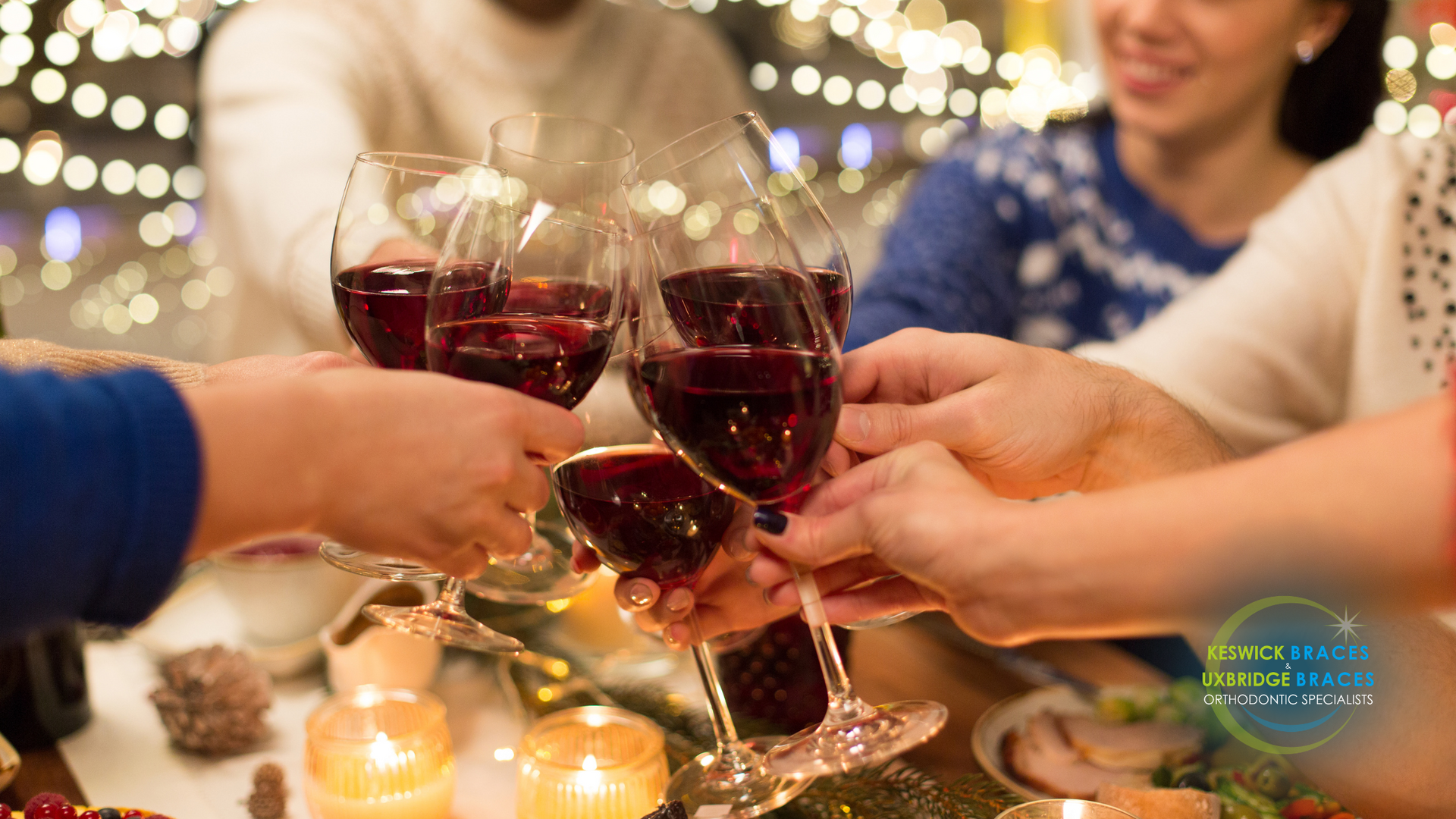 A group of people are toasting with wine glasses at a christmas party.