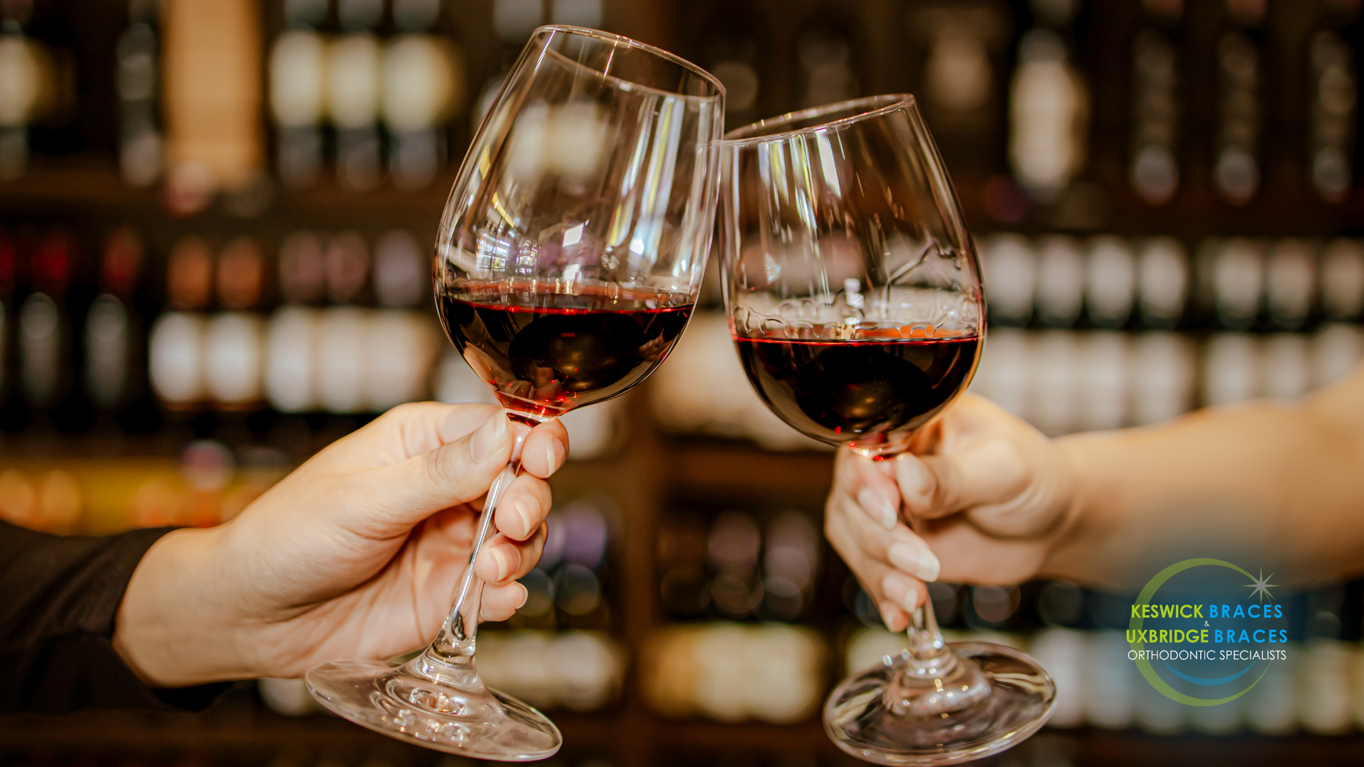 Two people are toasting with wine glasses in a bar.