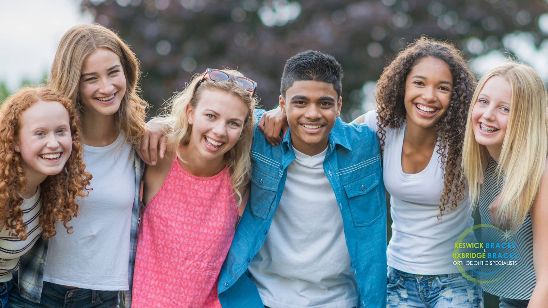 A group of young people are posing for a picture together.