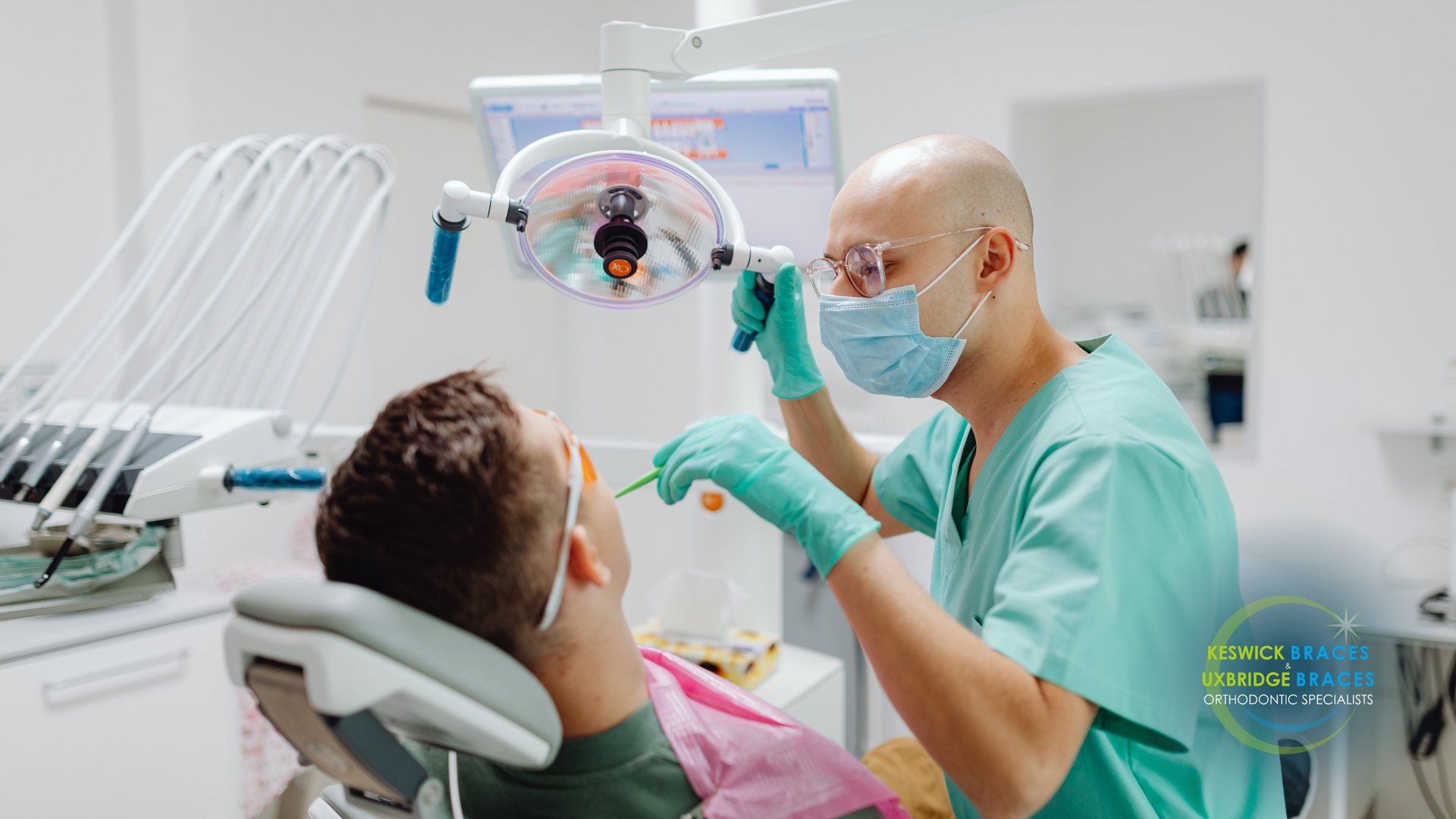 A dentist is examining a patient 's teeth in a dental office.