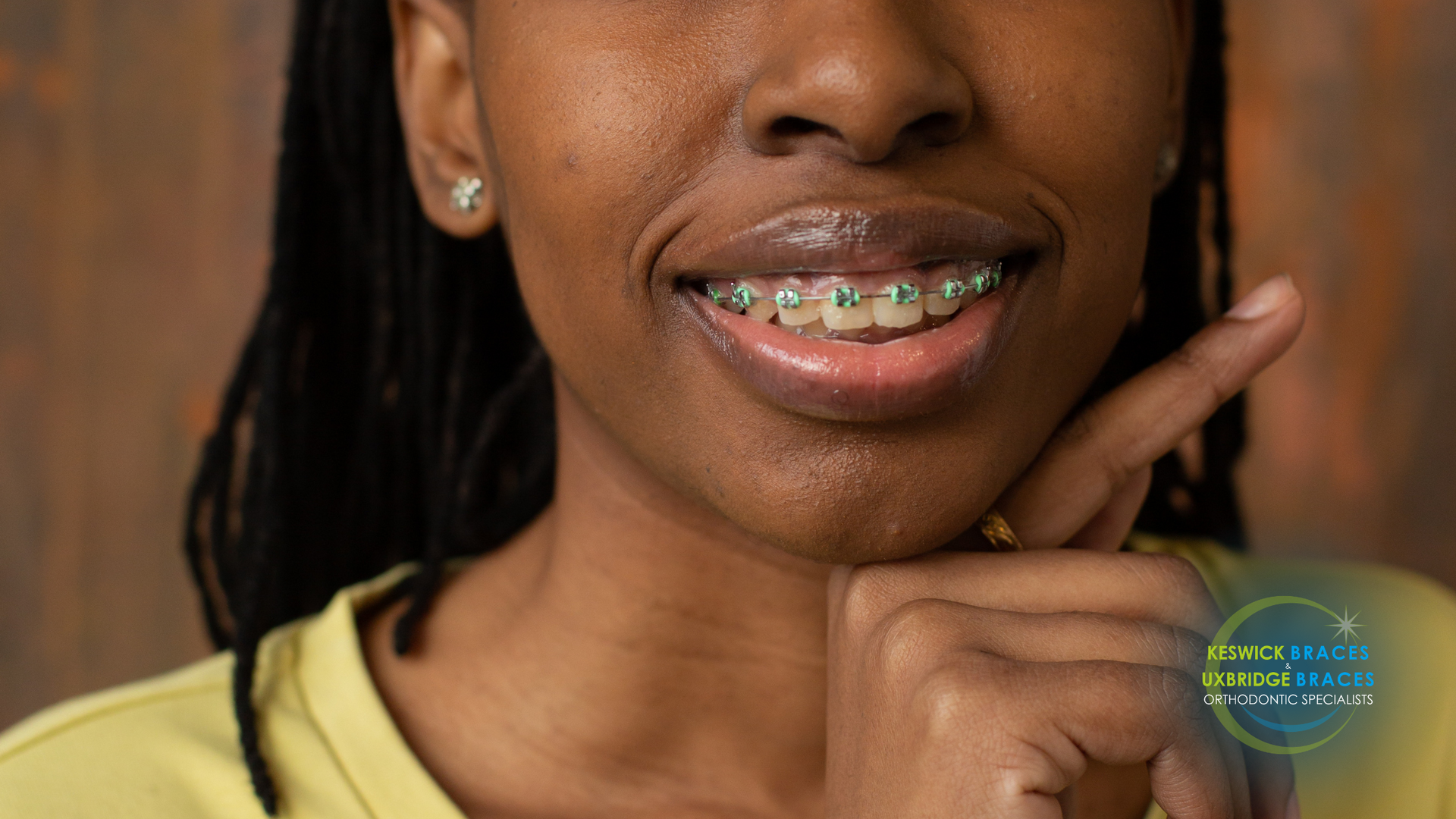 A close up of a woman 's face with braces on her teeth.