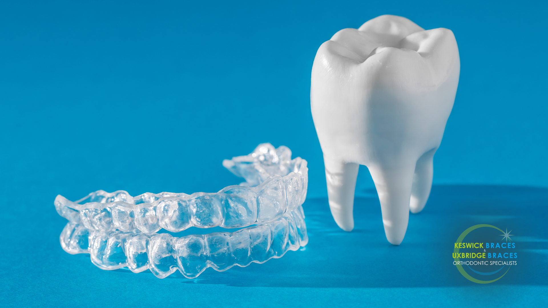 A tooth and a clear retainer on a blue background