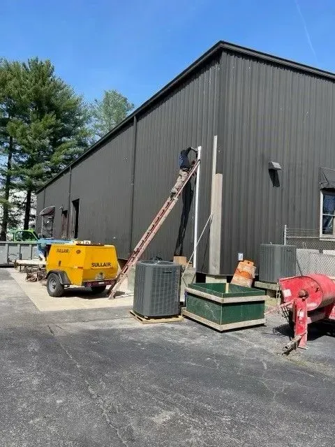 A yellow truck is parked in front of a building