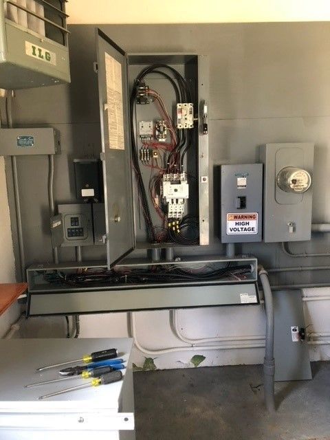 An electrical box with a warning sign on it