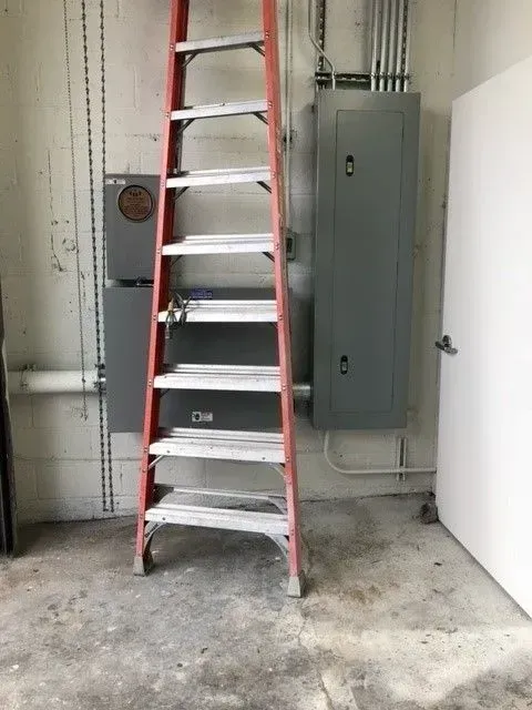 A ladder is leaning against a wall in a room.