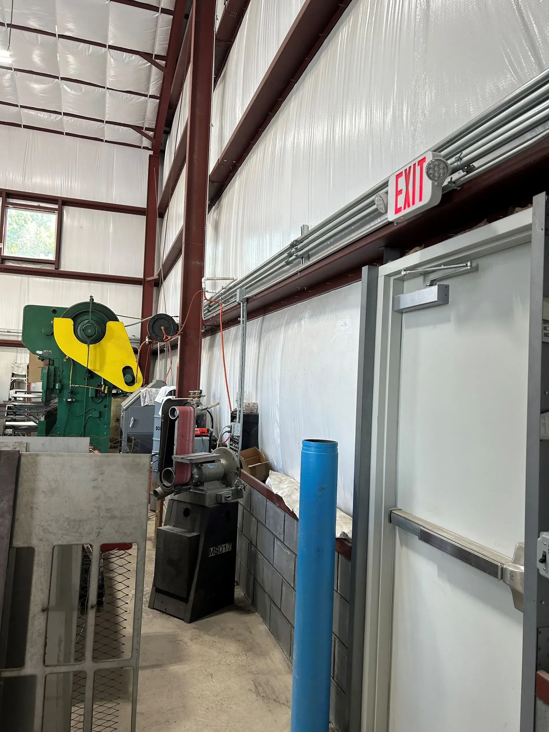 An exit sign is above a door in a building