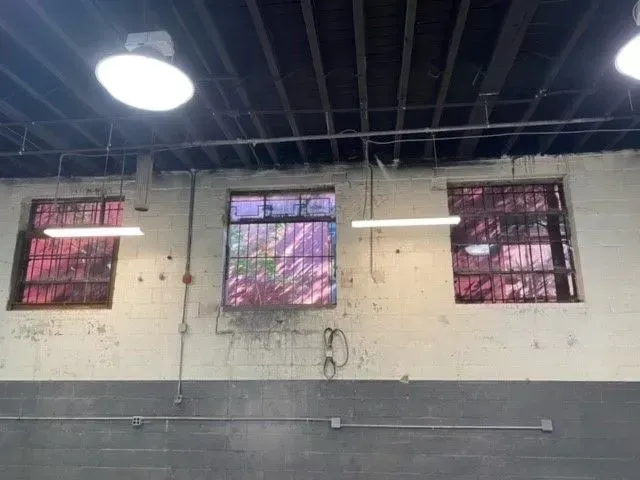 A room with three windows and a ceiling light.