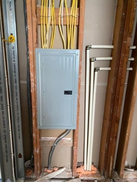 A wall with electrical wires coming out of it