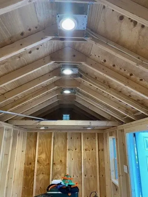 A room with a wooden ceiling and a window.