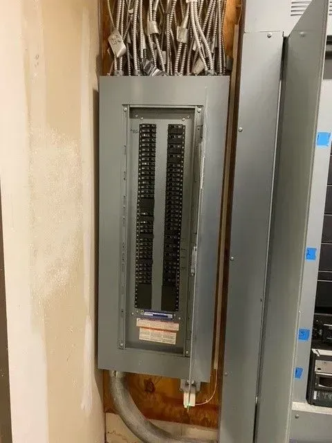 A electrical box with a lot of wires coming out of it.