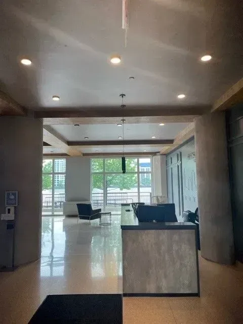 A large room with a desk and chairs in it