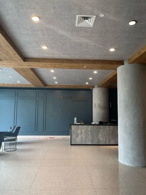 A large room with a reception desk and chairs