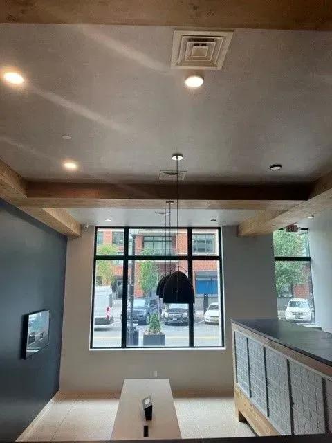 A room with a table and a large window