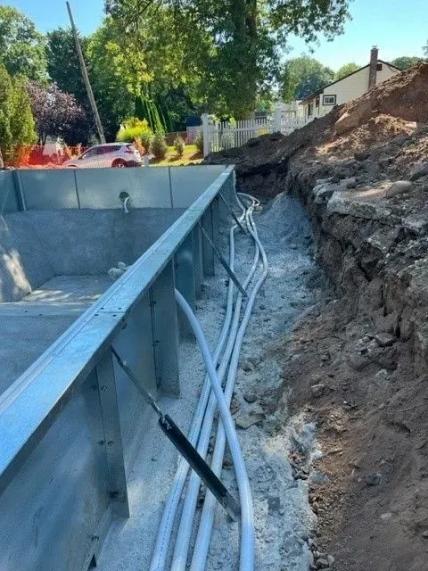 A bunch of wires are coming out of a hole in the ground