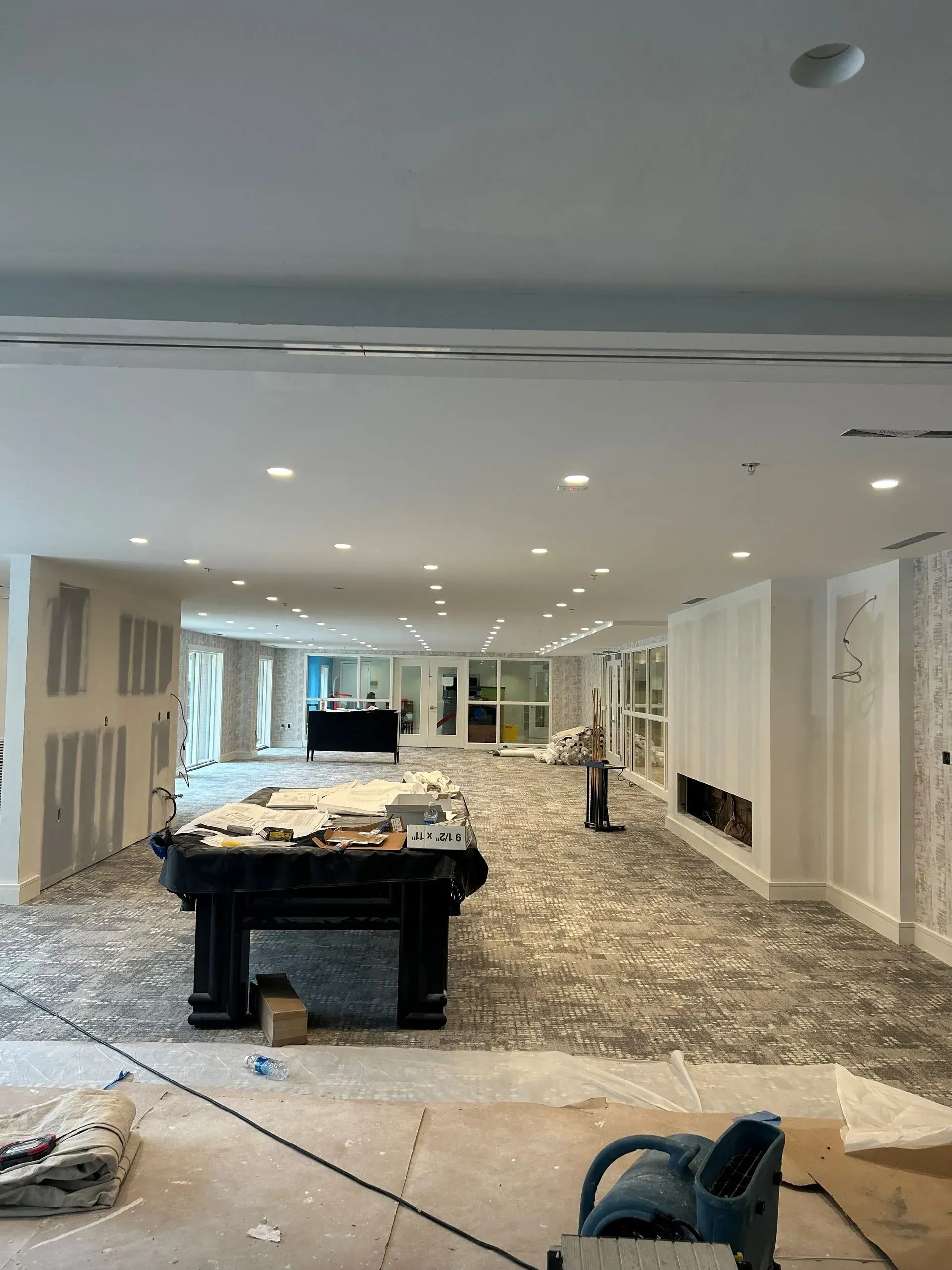 A large room with a pool table in the middle