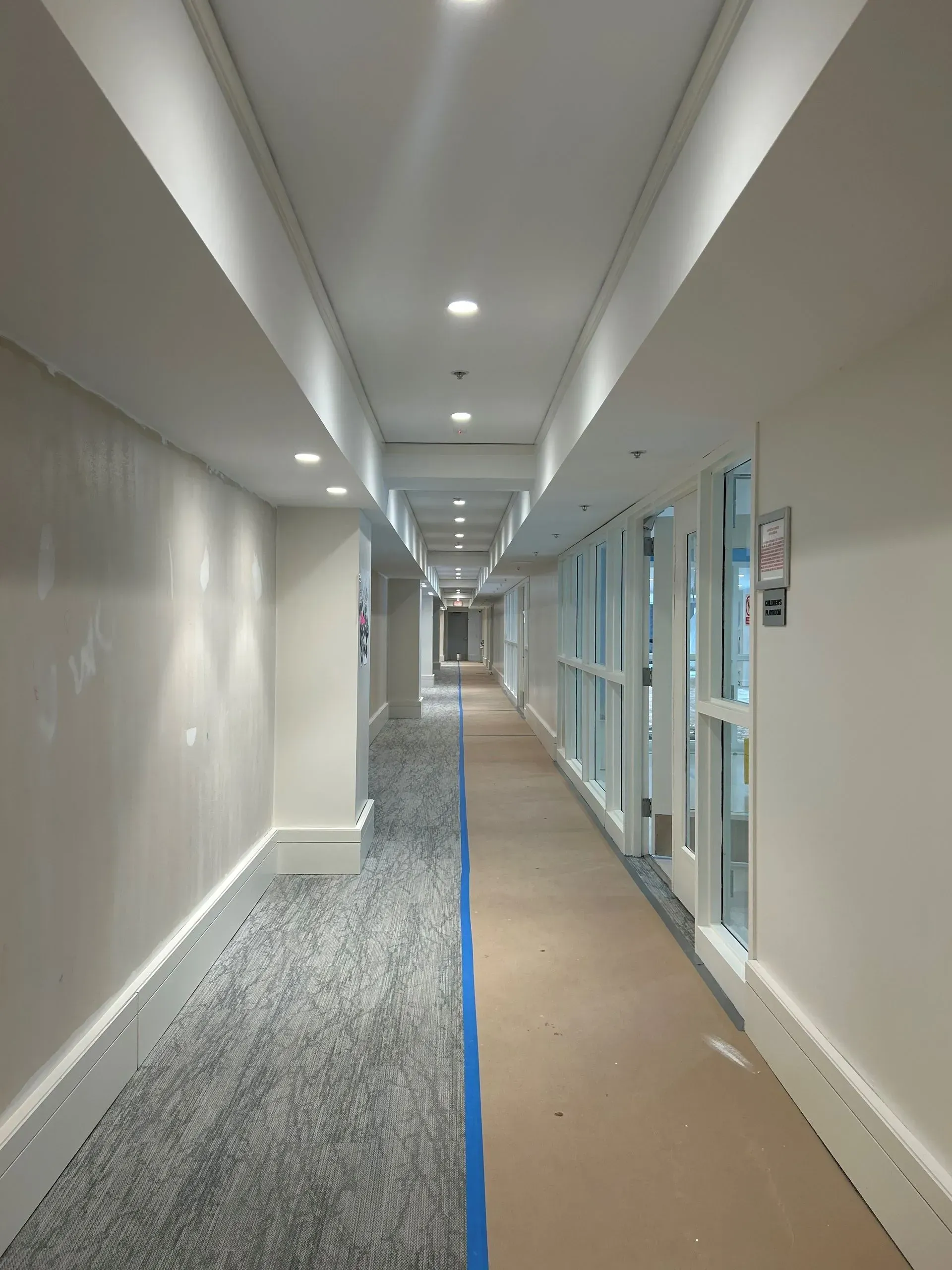 A long hallway with a blue line in the middle