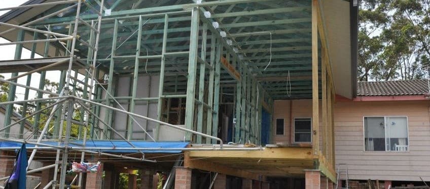 A house is being built with scaffolding around it.