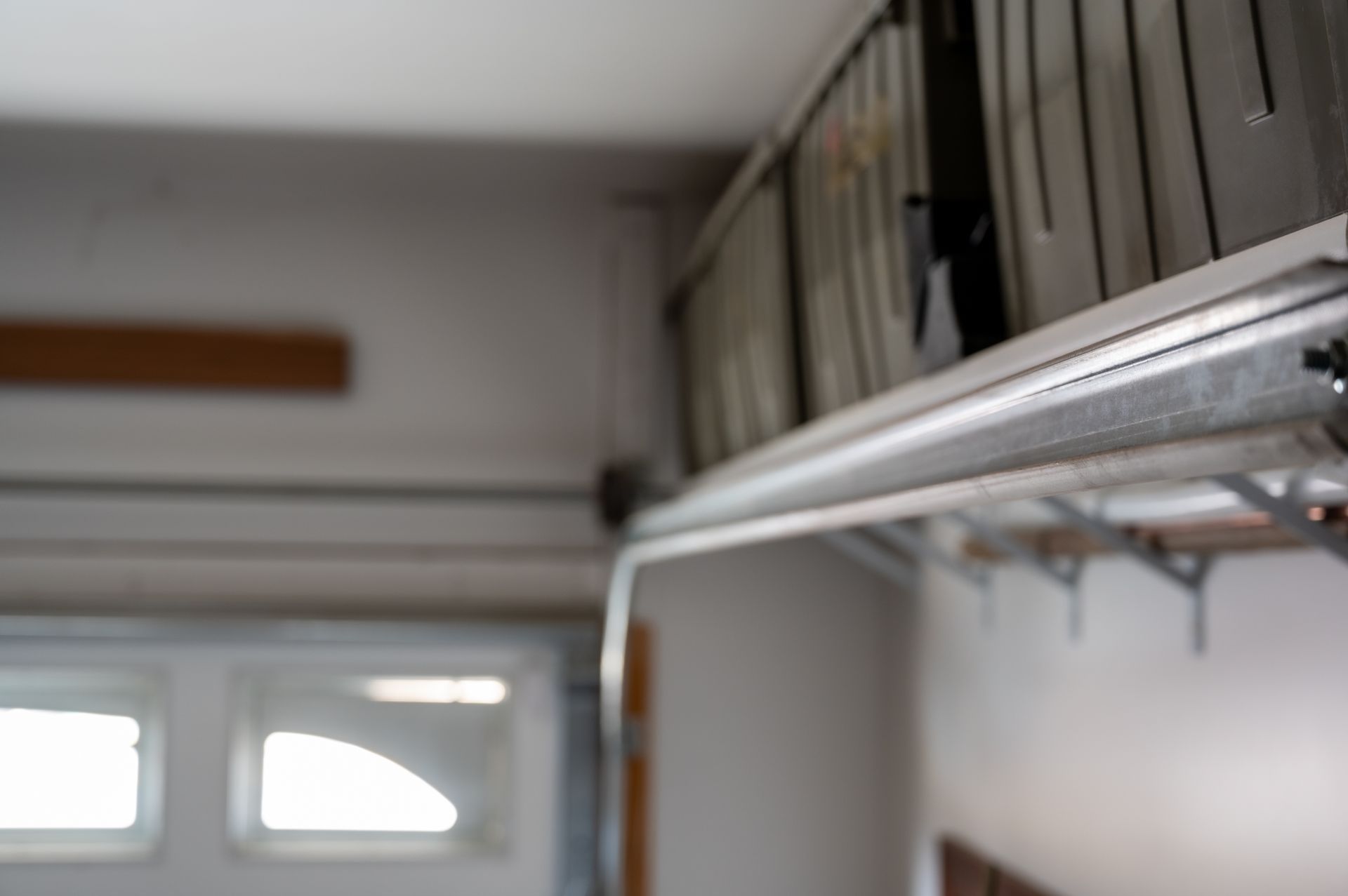 Garage ceiling with metal storage shelves and a closed garage door in the background