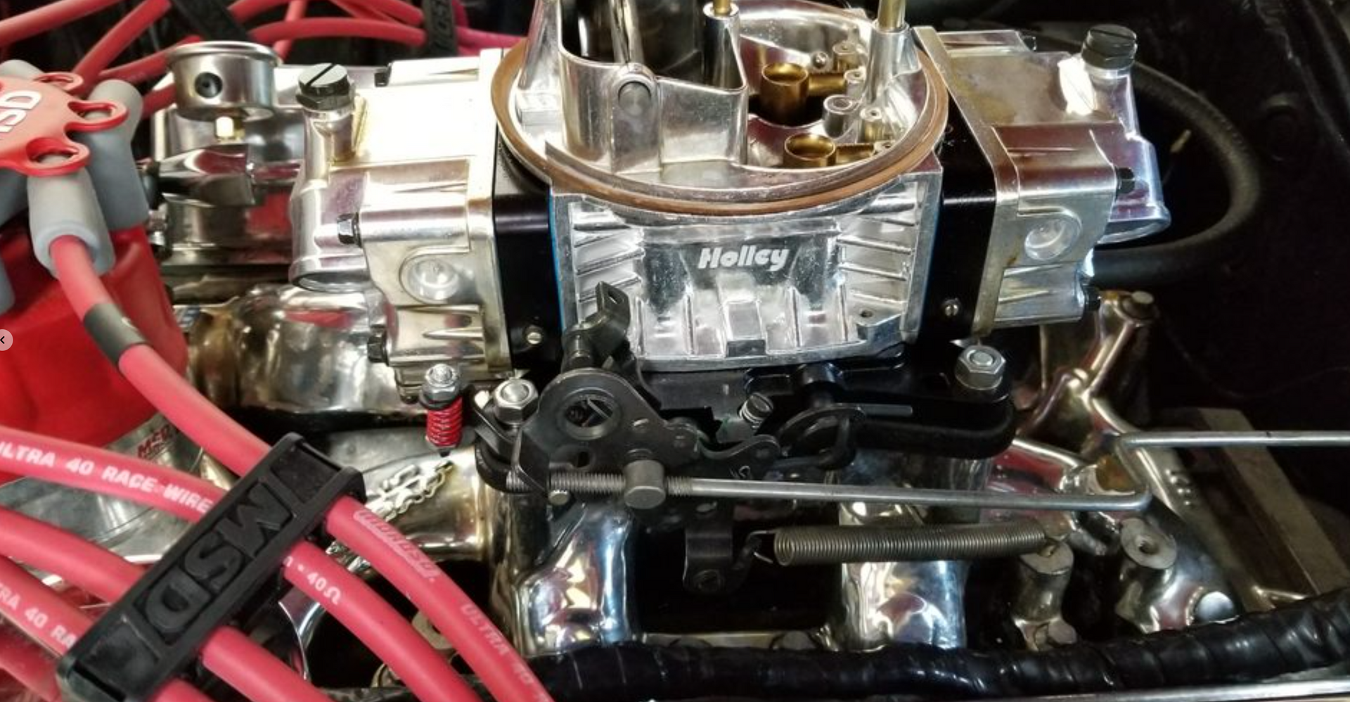 A close up of a carburetor on a car engine