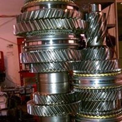 A stack of metal gears sitting on top of each other in a garage.