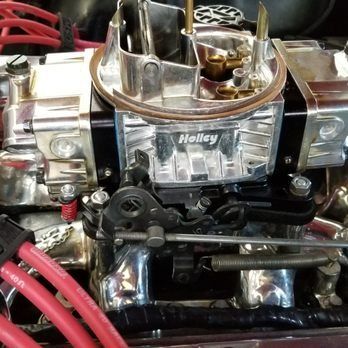 A close up of a holley carburetor on a car engine