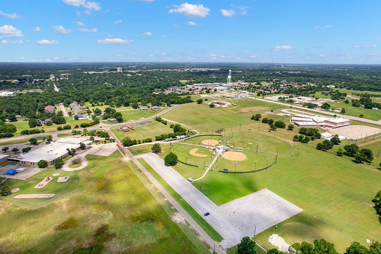 An aerial view of a baseball field in a small town.