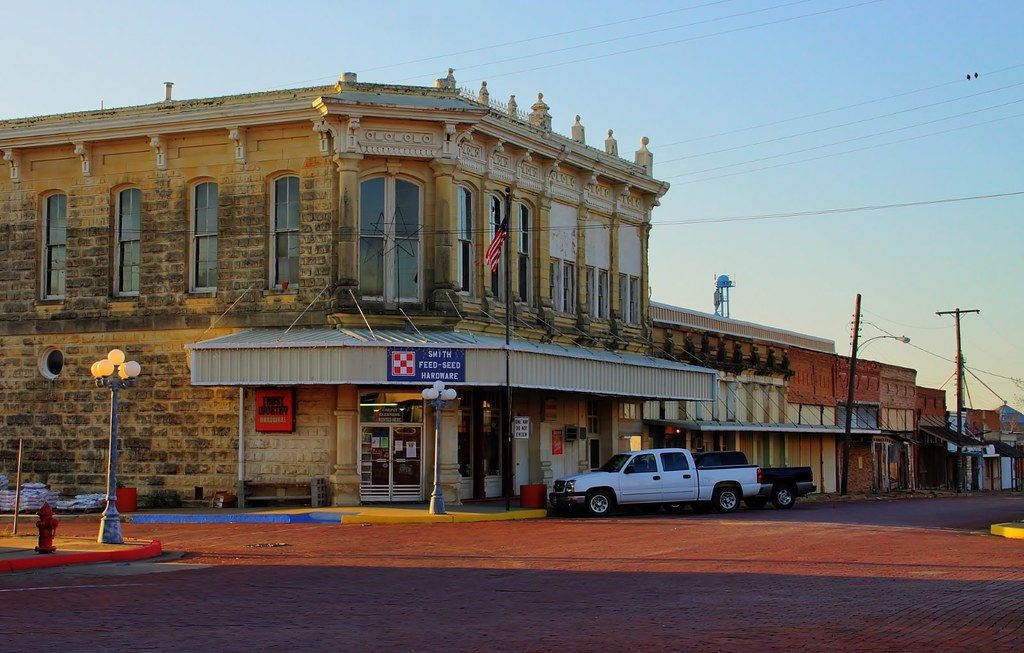 Historic stone building housing Smith Feed-Seed Hardware in downtown Paris, TX