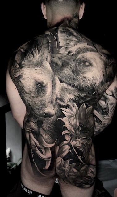 large back tattoo of wolves 