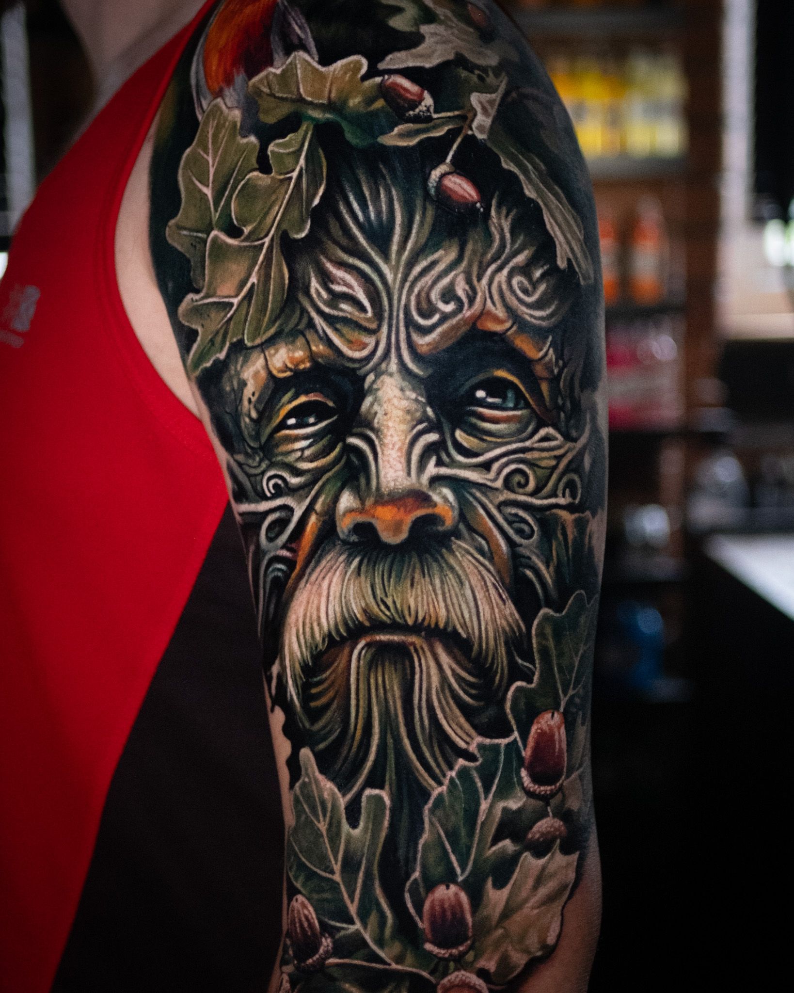 Colour tattoo on the higher arm of a green man