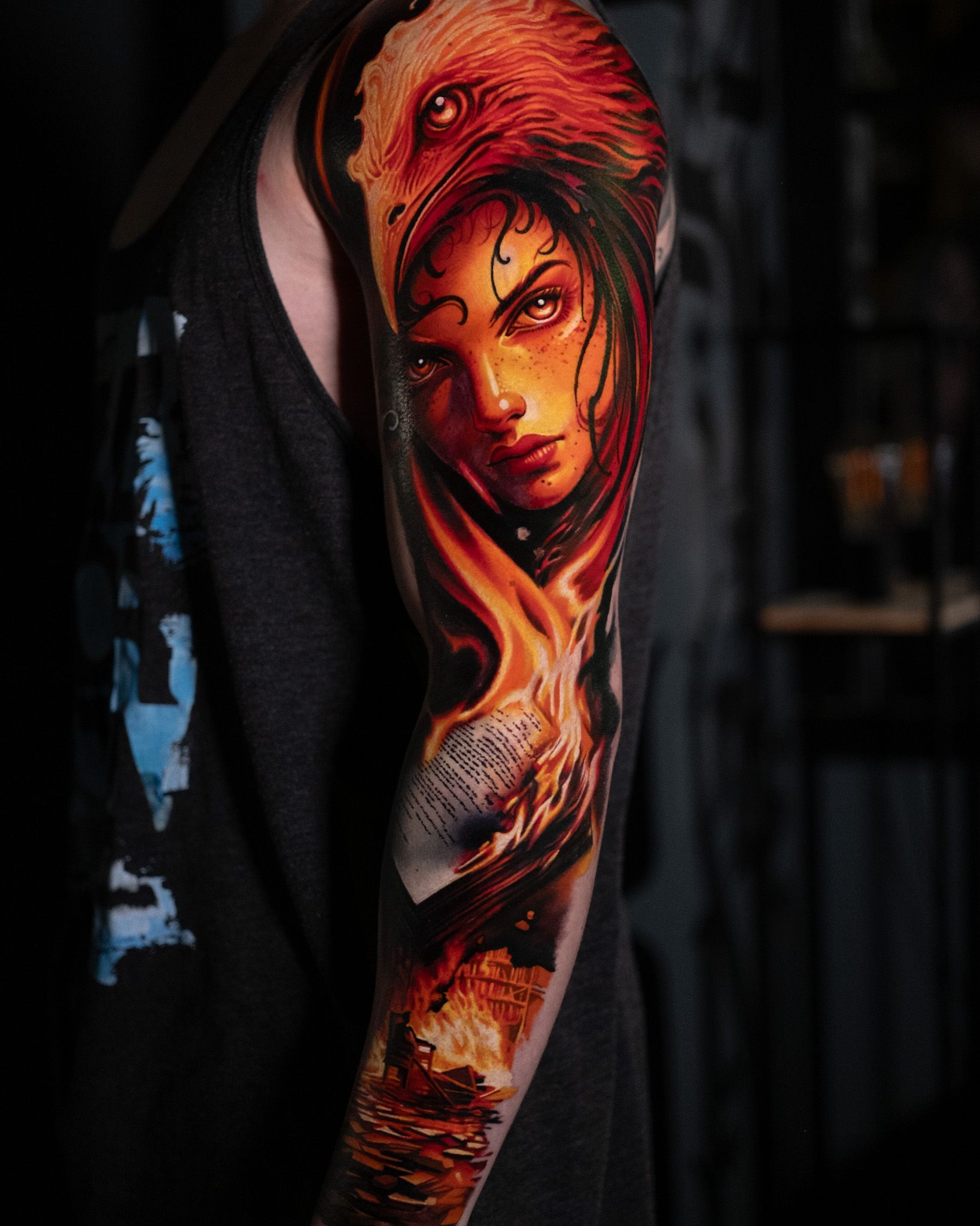 Colourful arm sleeve tattoo with realistic flames and a woman