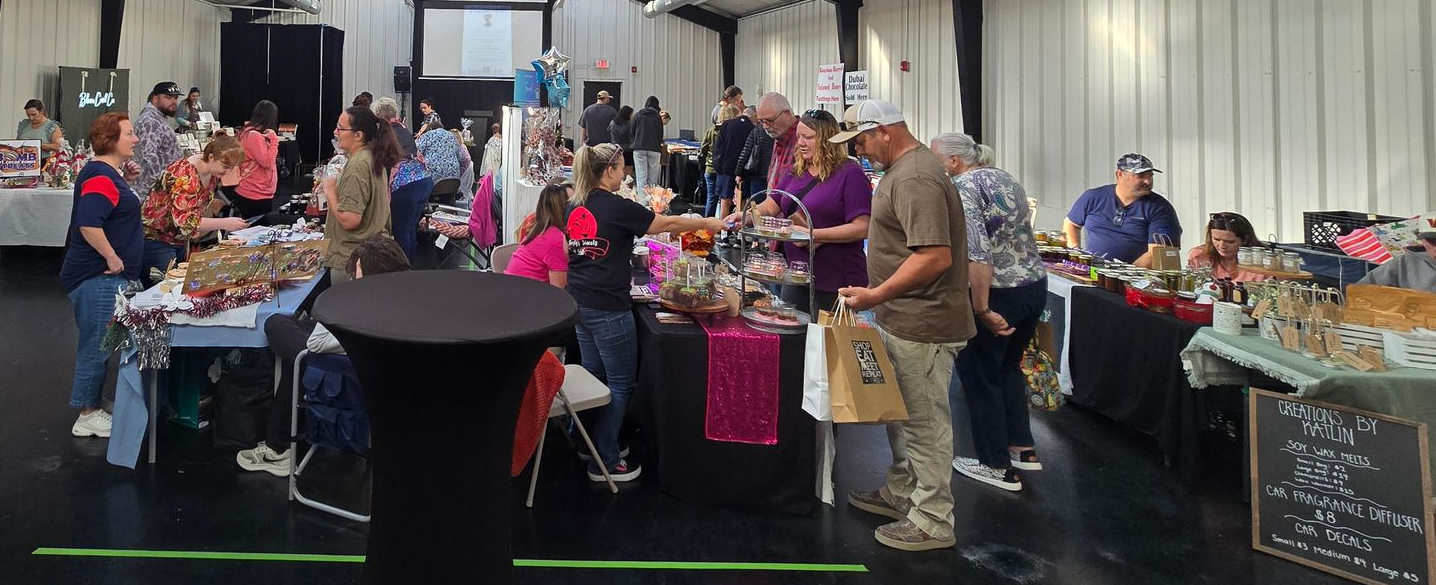 Town Market at Venue 601 with indoor vendor booths, shoppers browsing local products, and busy community atmosphere in downtown Elizabeth City NC