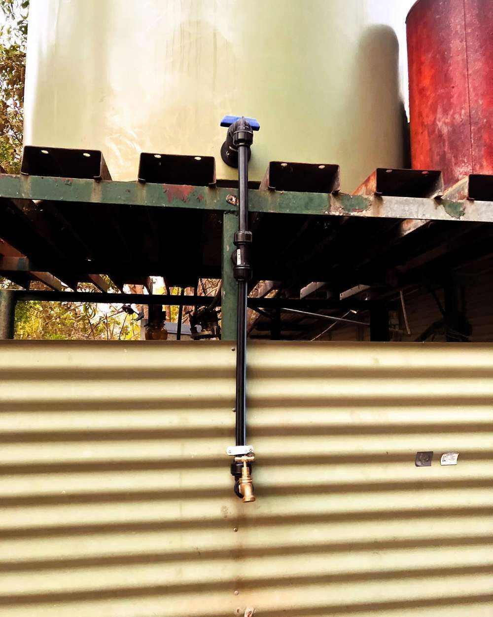 A Water Faucet Is Attached To A Metal Wall — Fewmore Contracting In Tennant Creek, NT
