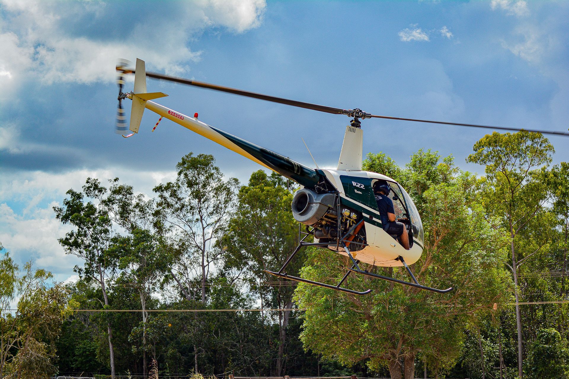 A Small Helicopter is Flying Over a Forest — Fewmore Contracting in Palmerston, NT
