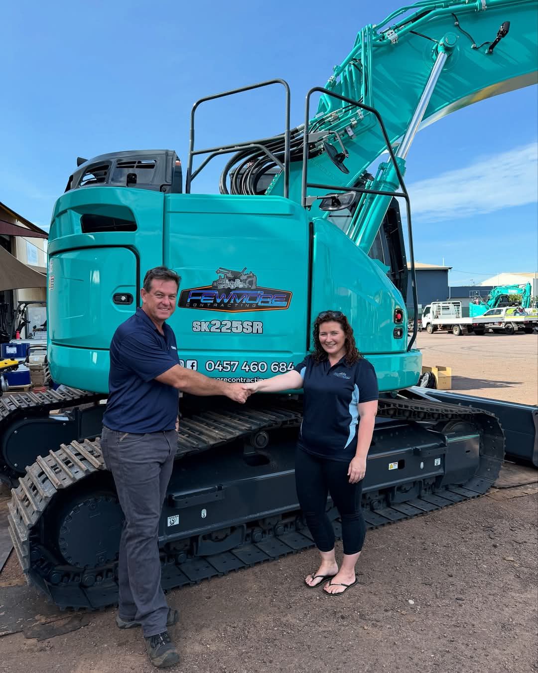 An Aerial View of a Bulldozer and a Truck on a Dirt Road — Fewmore Contracting in Yarrawonga, NT