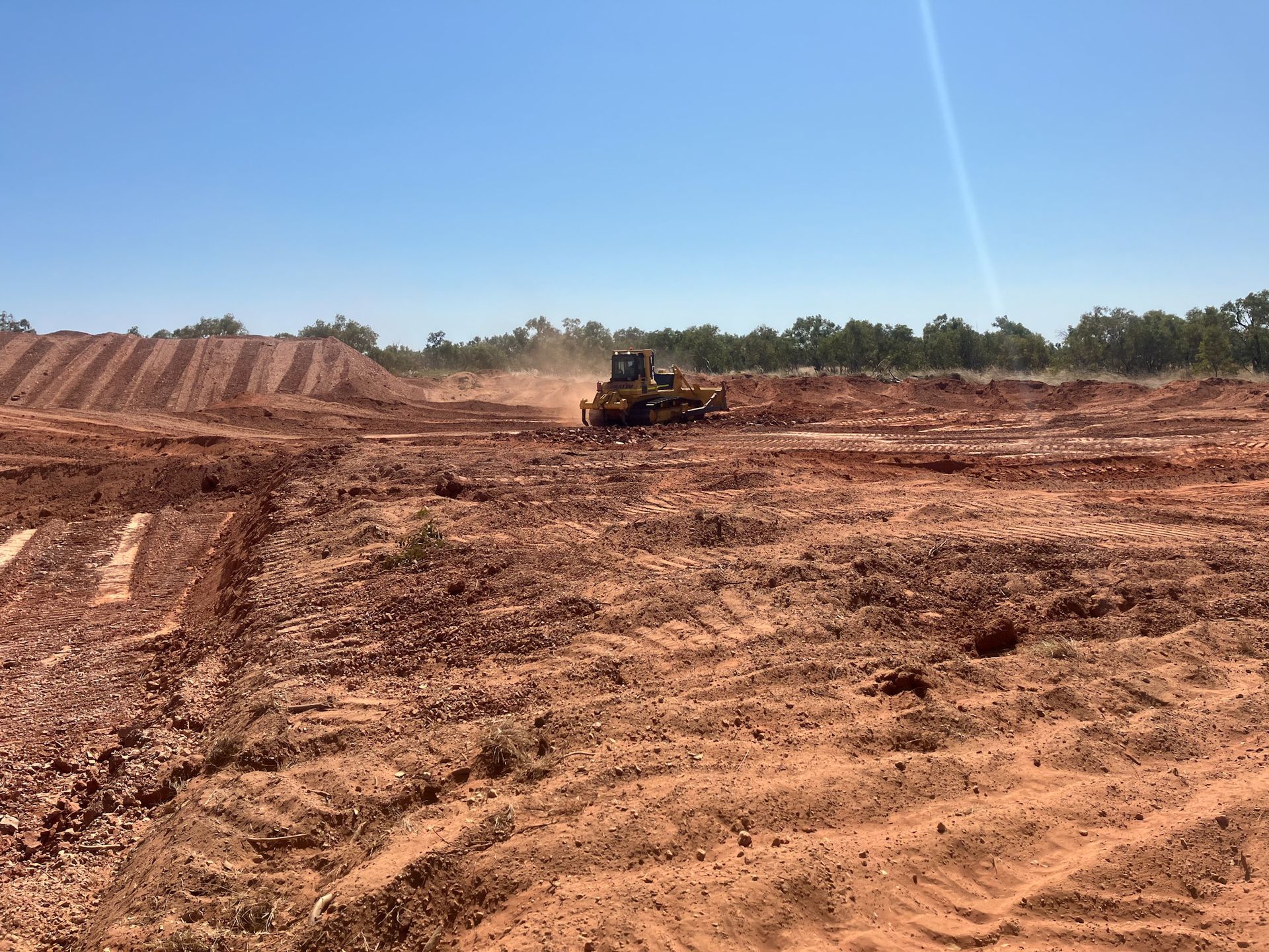 A Bulldozer is Working on a Dirt Field — Fewmore Contracting in Yarrawonga, NT