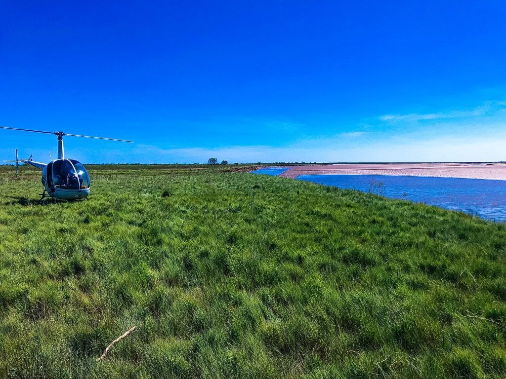 A Black Helicopter Is Parked On A Runway — Fewmore Contracting in Yarrawonga, NT
