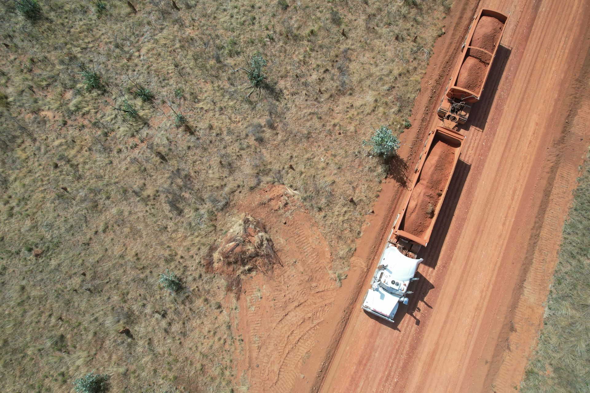 An Aerial View of a Truck Driving Down a Dirt Road — Fewmore Contracting in Katherine, NT