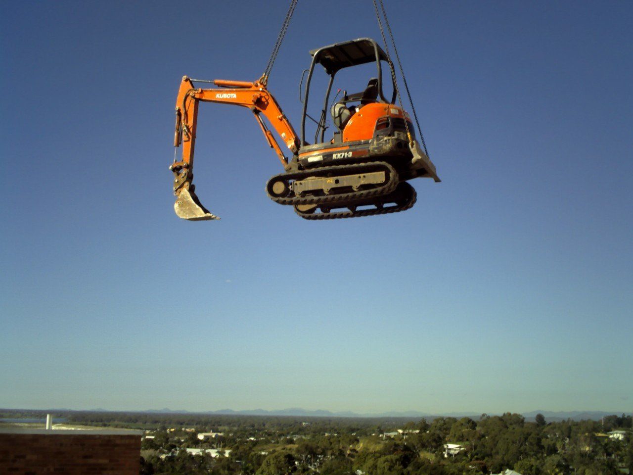 Excavator Standing in Sandpit with Raised Bucket — Greg Thompson Earthmoving in Pink Lily, QLD