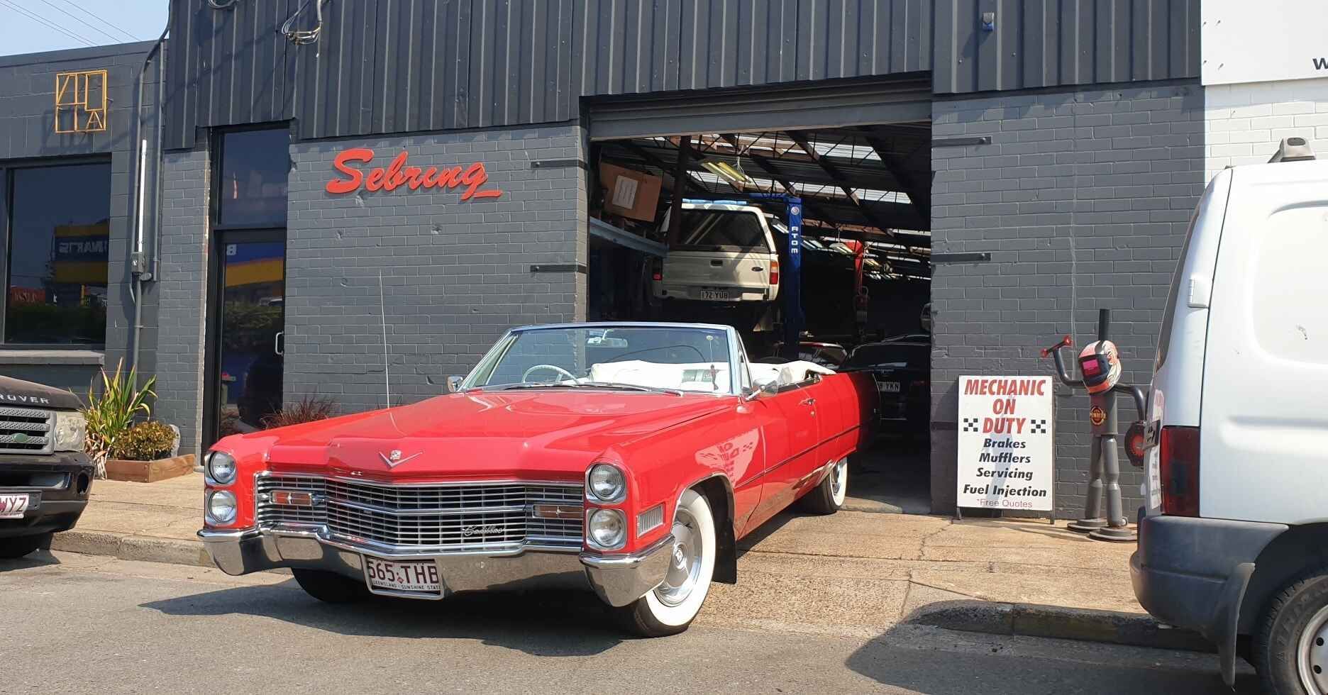 A Red Convertible is Parked in Front of a Garage — Sebring All Mechanical Repairs In Mermaid Beach, QLD