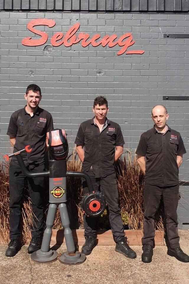 Three Men Are Standing Next To Each Other — Sebring All Mechanical Repairs In Mermaid Beach, QLD
