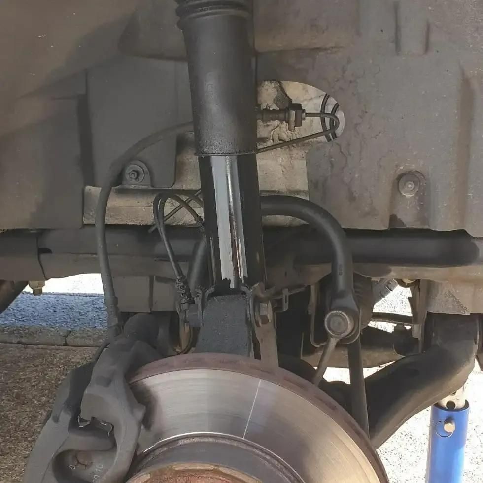 Close Up of a Shock Absorber and Brake Disc on a Car β Sebring All Mechanical Repairs In Mermaid Beach, QLD