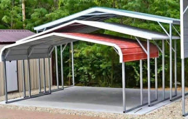 Three-car metal carport with gray, white, and red roofs on a concrete slab outdoors