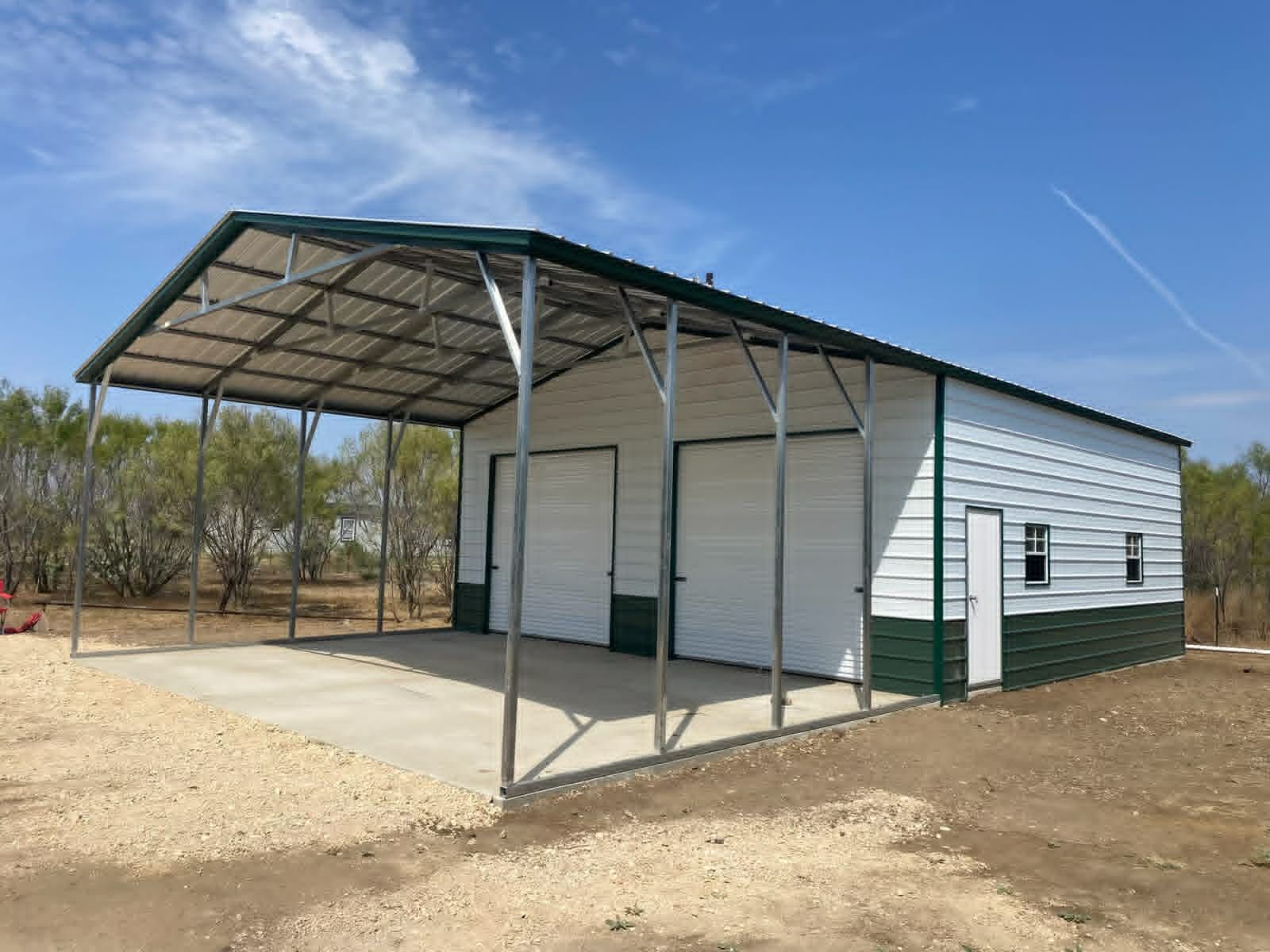 Small white metal building with a covered front porch in a dry, open area under a blue sky